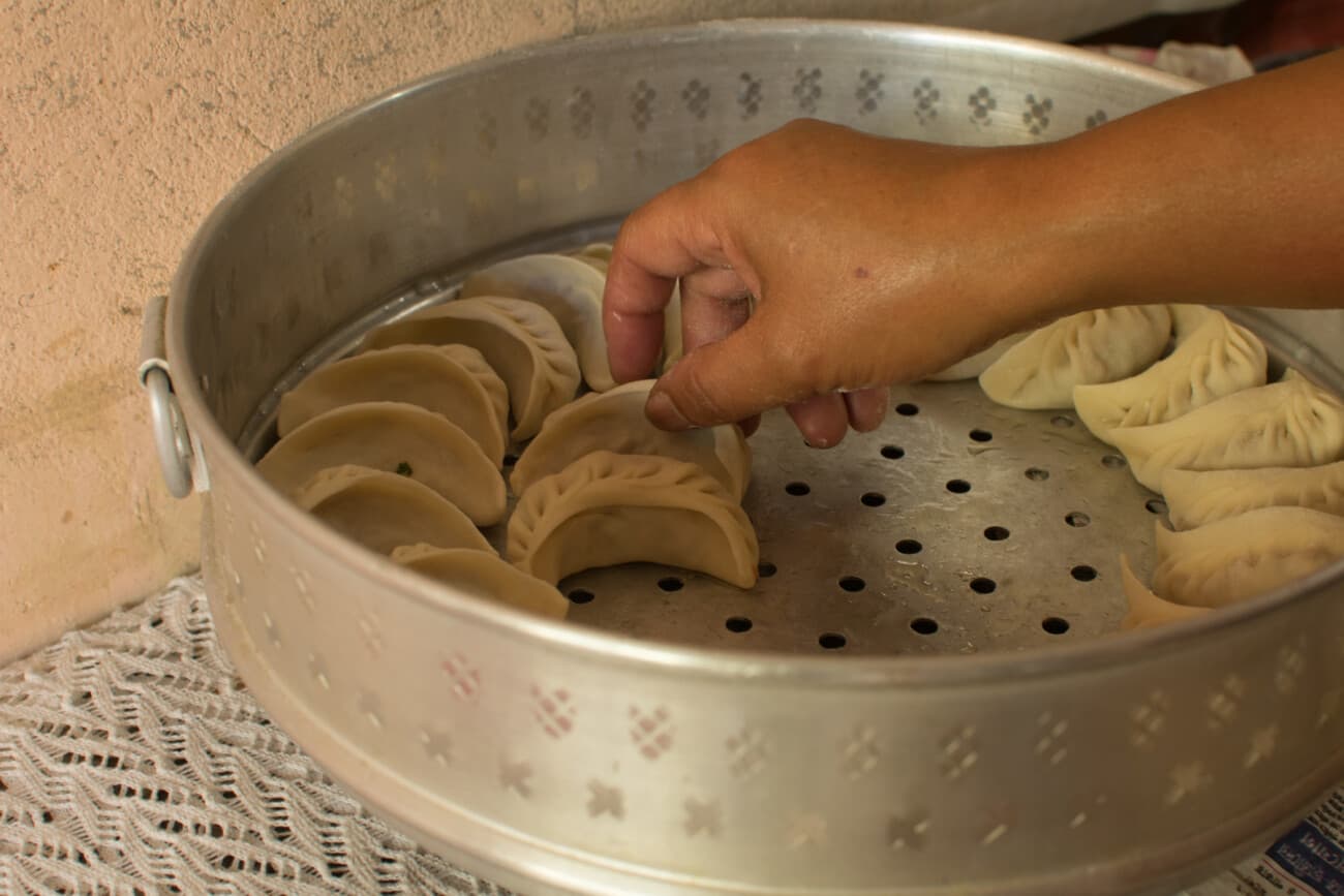Fresh momos and chicken items being prepared